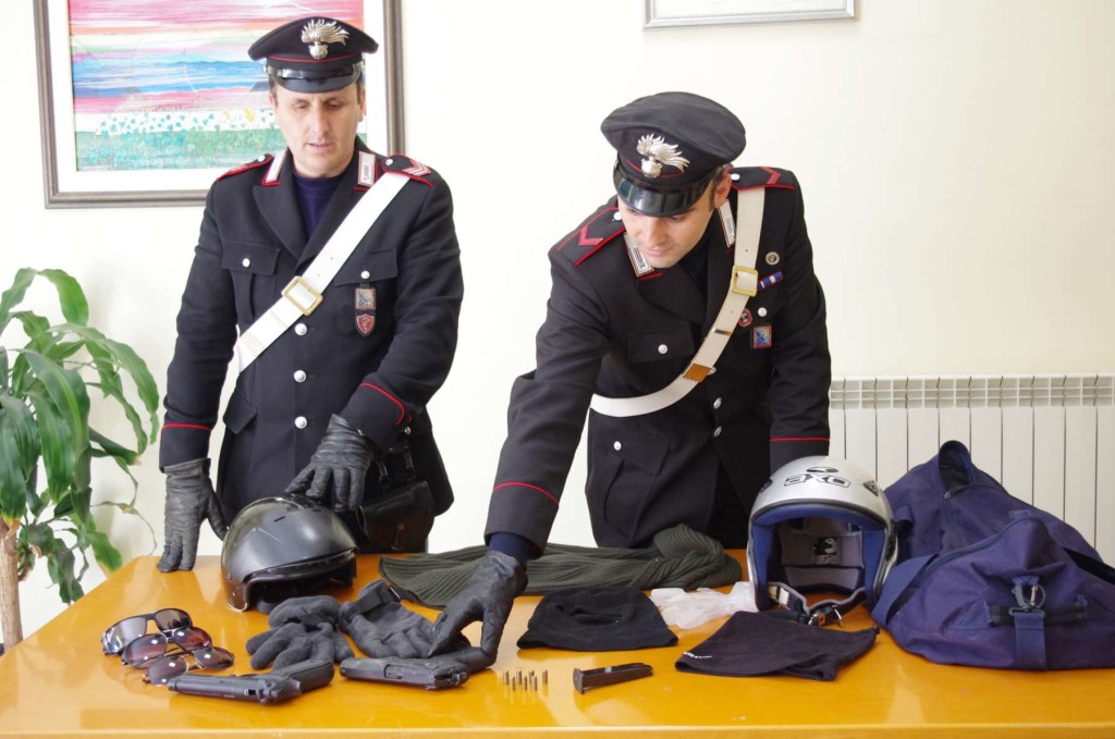 Le pistole e gli indumenti sequestrati dai Carabinieri